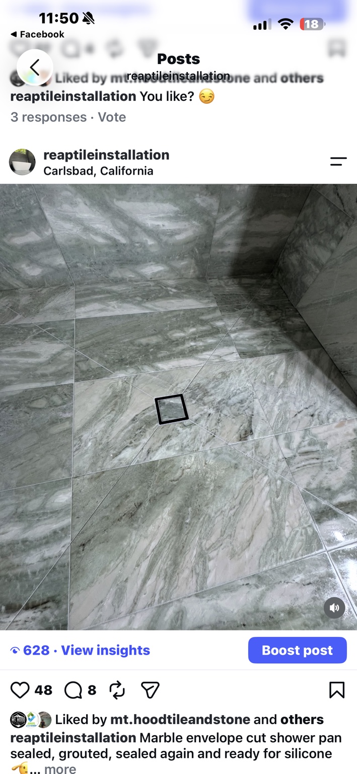 Marble tile shower floor with envelope cuts around a square drain